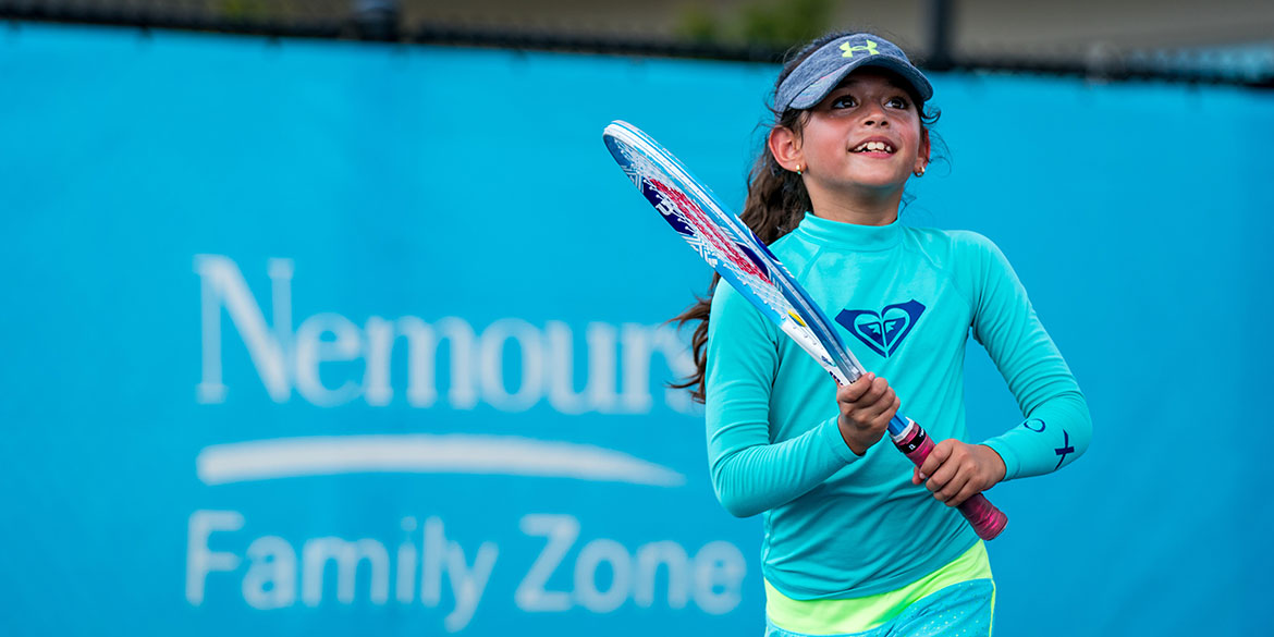 Young girl playing tennis at the USTA National Campus.