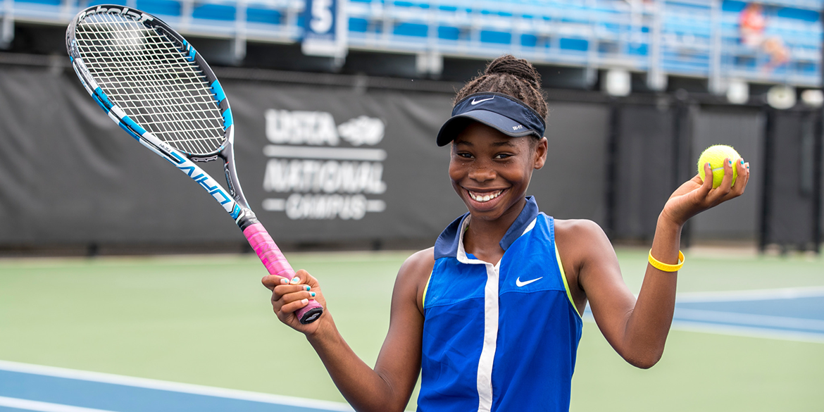 Young boy playing tennis at the USTA National Campus.