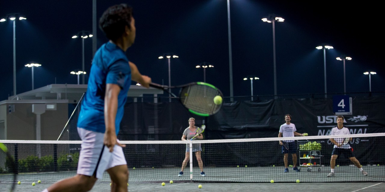 People playing tennis at the USTA National Campus.