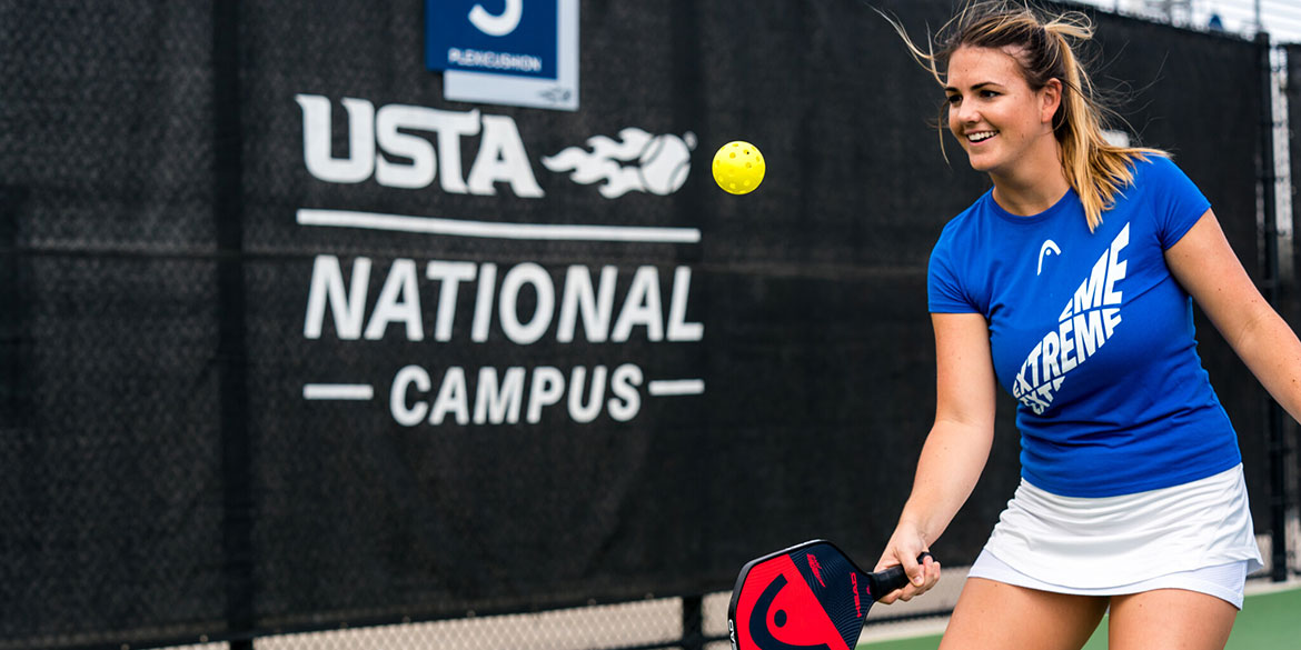 Young boy playing tennis at the USTA National Campus.
